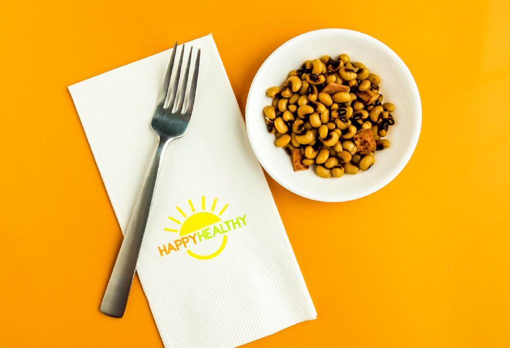 bowl of black-eyed peas beside fork and napkin.