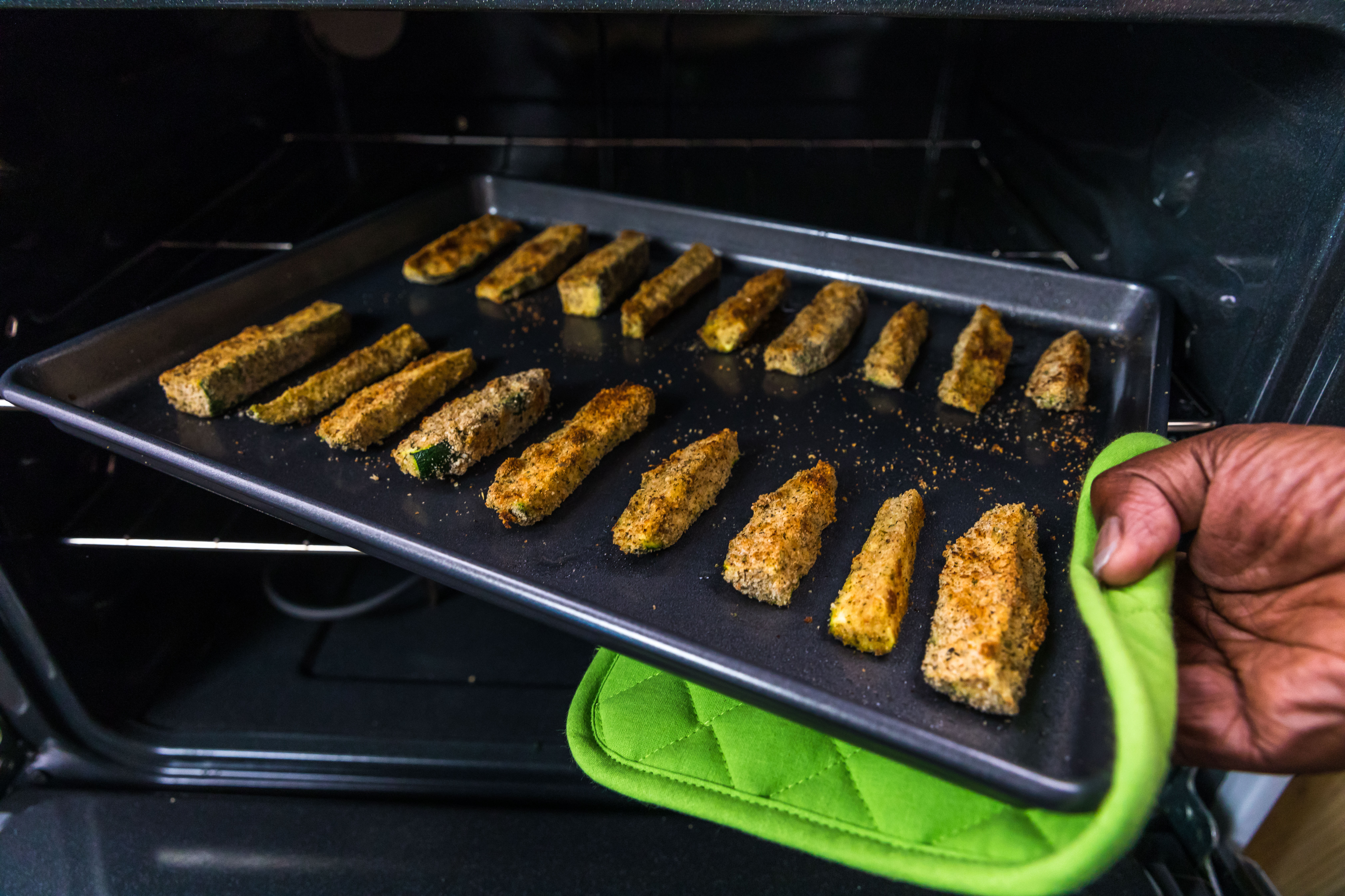 Roasted zucchini on a baking sheet in the oven