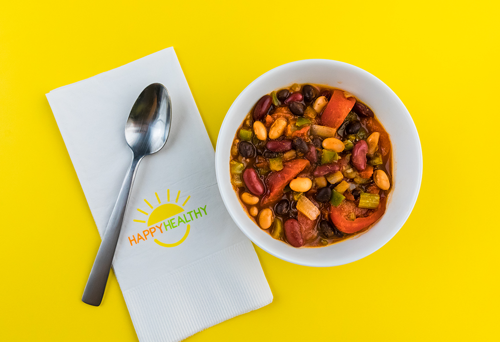 3 Bean Chili in a bowl with a spoon on a HappyHealthy napkin.