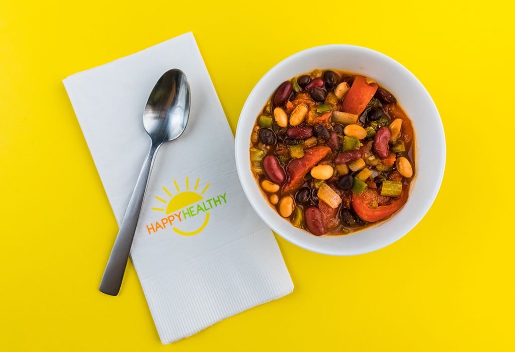 3 Bean Chili in a bowl with a spoon on a HappyHealthy napkin.