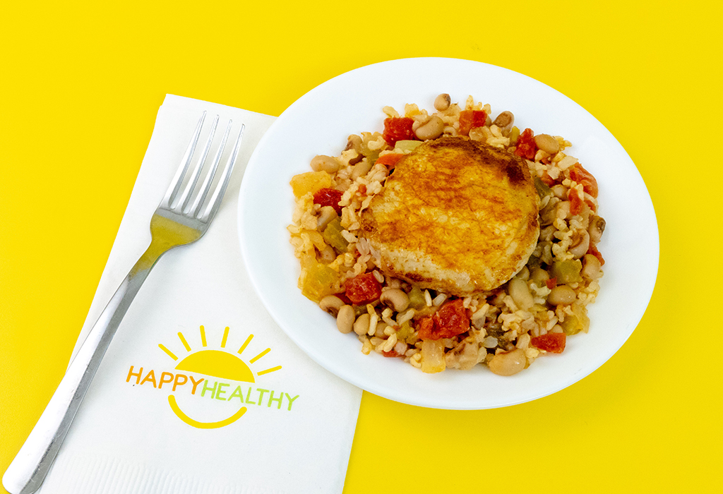 a plate of Pork Chops over Vegetable Rice