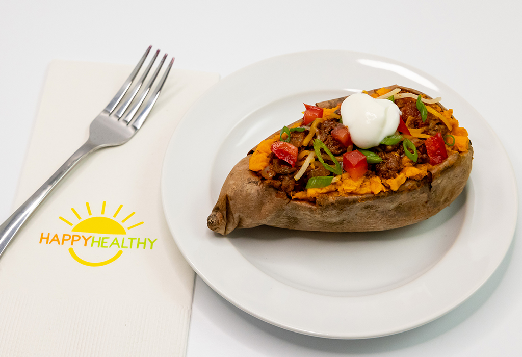 A plate with a taco stuffed sweet potato