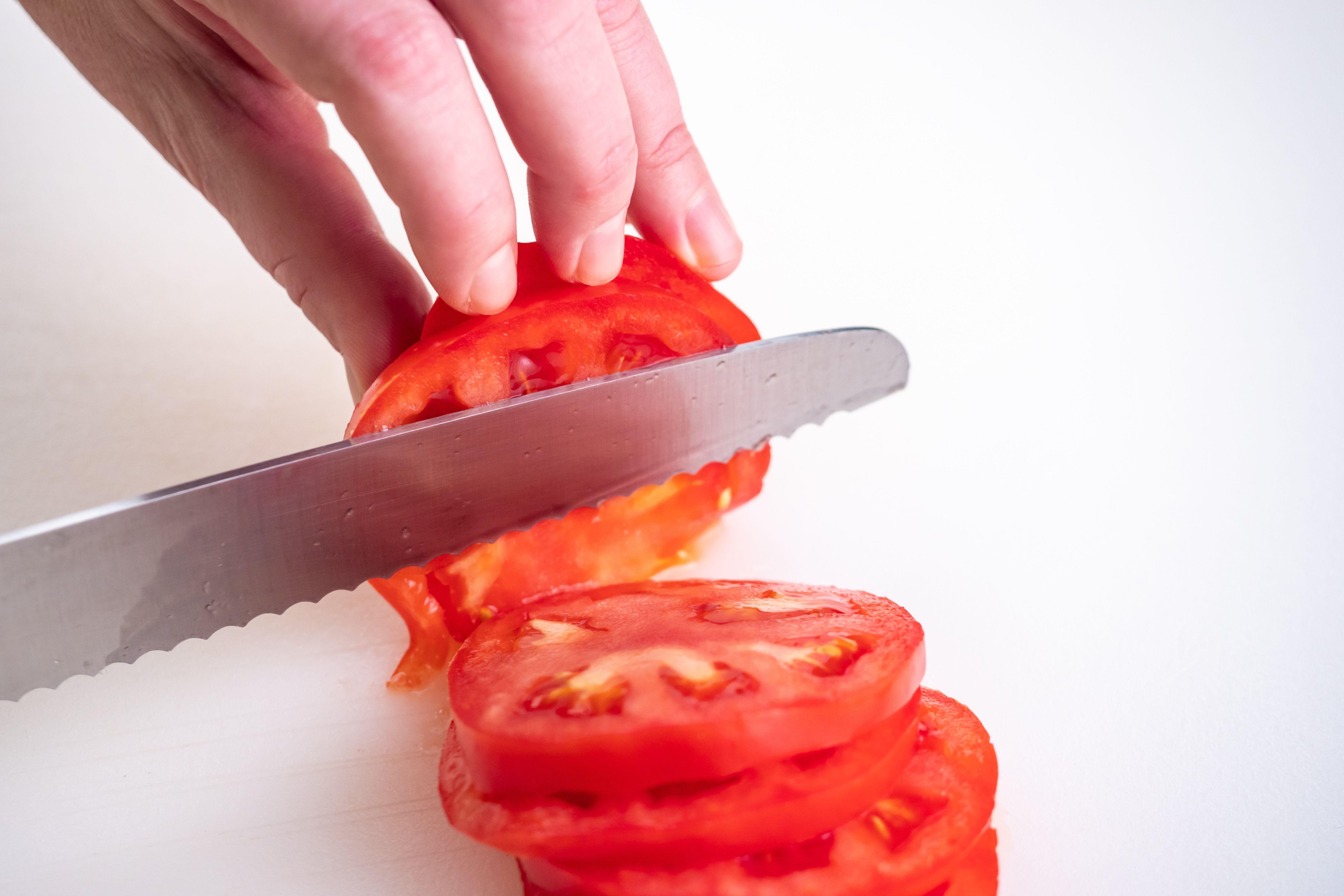 A woman slicing tomato