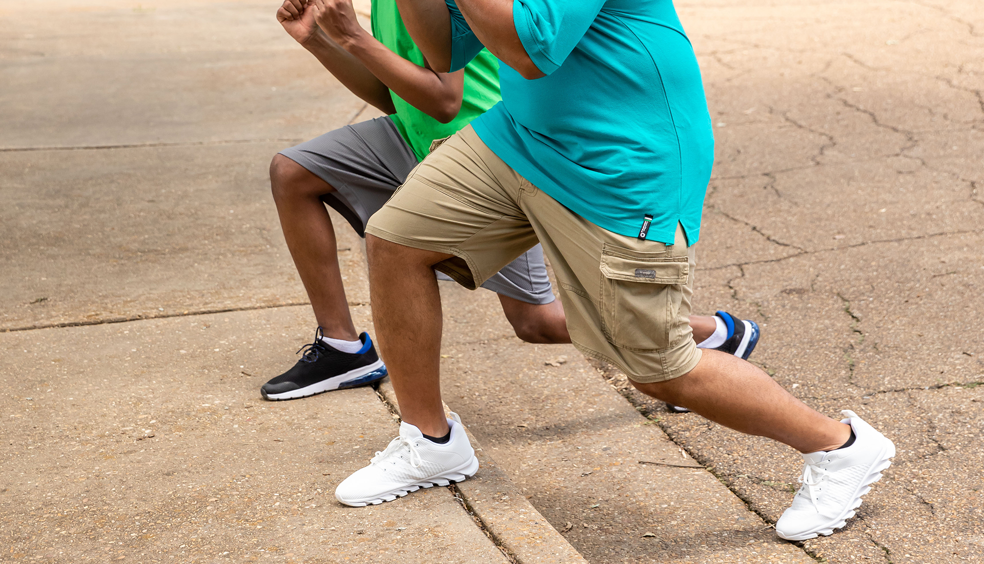 Two men stepping on a curb