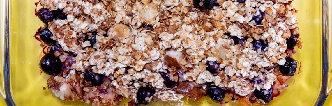 A baked dish of pear and blueberry crisp