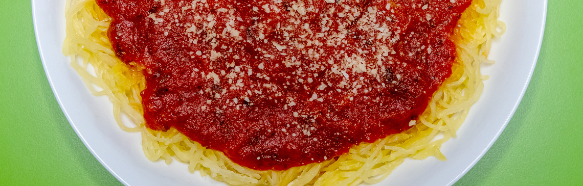 A plate of spaghetti sauce topped with tomato sauce