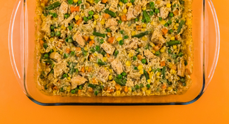 Chicken and rice casserole in glass baking dish.