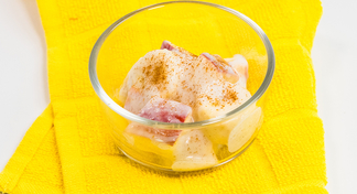A glass filled with chilled banana salad on a yellow background