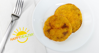 Two Oven Fried Green Tomatoes on a white plate next to a fork and HappyHealthy Napkin