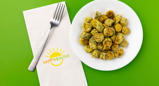 Fried okra bites on a white plate next to a HappyHealthy Napkin and Fork