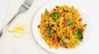 A plate of pasta with stir fried vegetables