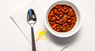 Bowl of quick chili with a spoon and Happy Healthy napkin