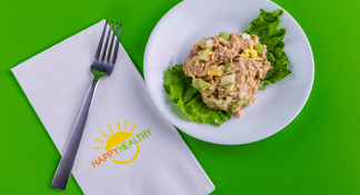 Plate of tuna salad by a fork with a napkin