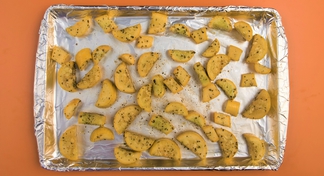 foil-covered baking sheet with salt and peppered squash slices