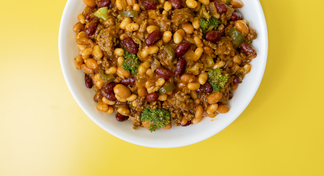 A white bowl filled with Beef, Bean and Broccoli Skillet on a yellow background