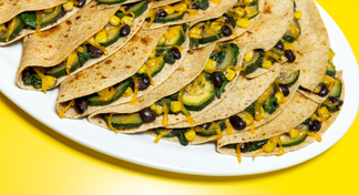  A white platter of black bean and vegetable quesadillas