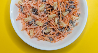 A white bowl filled with carrot salad