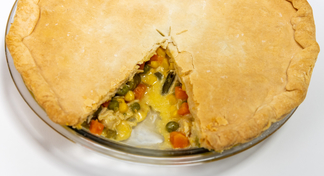 A chicken pot pie with one piece missing