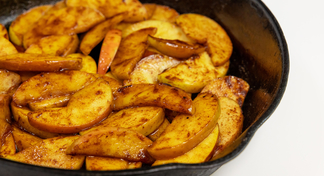 A pan of Hot Cinnamon Apples on a white background