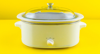 White slow cooker with yellow background.
