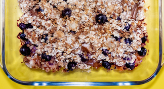 A baked dish of pear and blueberry crisp