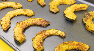A baking pan of roasted acorn squash arches