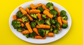A white bowl filled with roasted carrots and broccoli