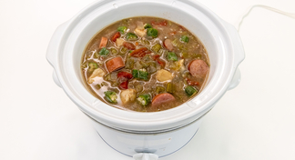 A white slow cooker full of Slow Cooker Gumbo on a white background