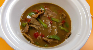 A serving bowl of Slow Cooker Steak and Peppers