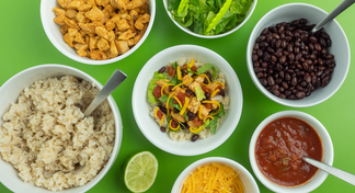Bowls of rice, chicken, lettuce, black beans, salsa, cheese and a central Southwest bowl