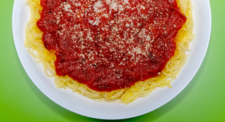 A plate of spaghetti sauce topped with tomato sauce