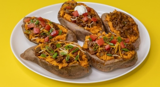 A plate of taco stuffed sweet potatoes