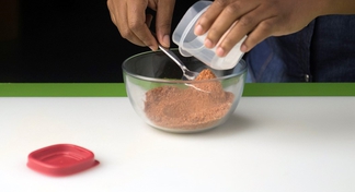 All purpose seasoning being scooped into a container