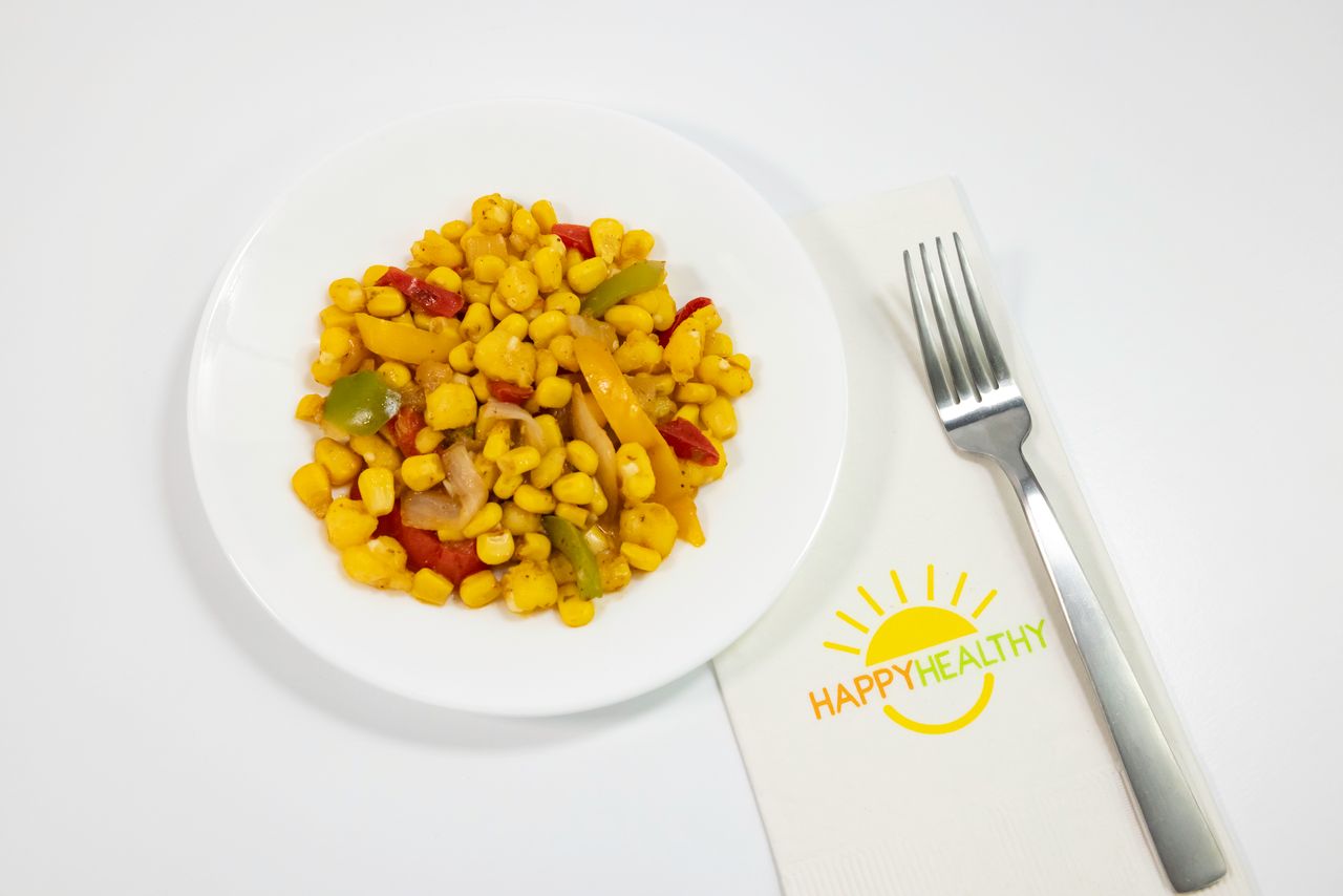 A white plate of Fiesta Hominy And Corn