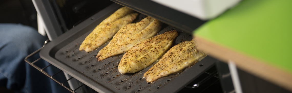 Chicken on baking sheet in oven.