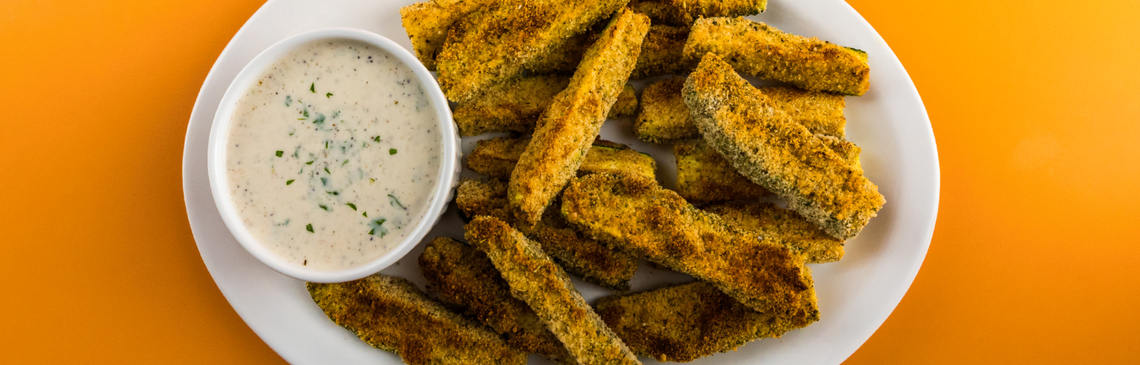 Plate with zucchini sticks and cup of low-fat ranch dressing.