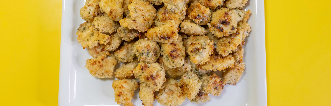 A white plate filled with chicken bites