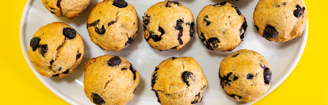 A white plate of carrot raisin zucchini muffins