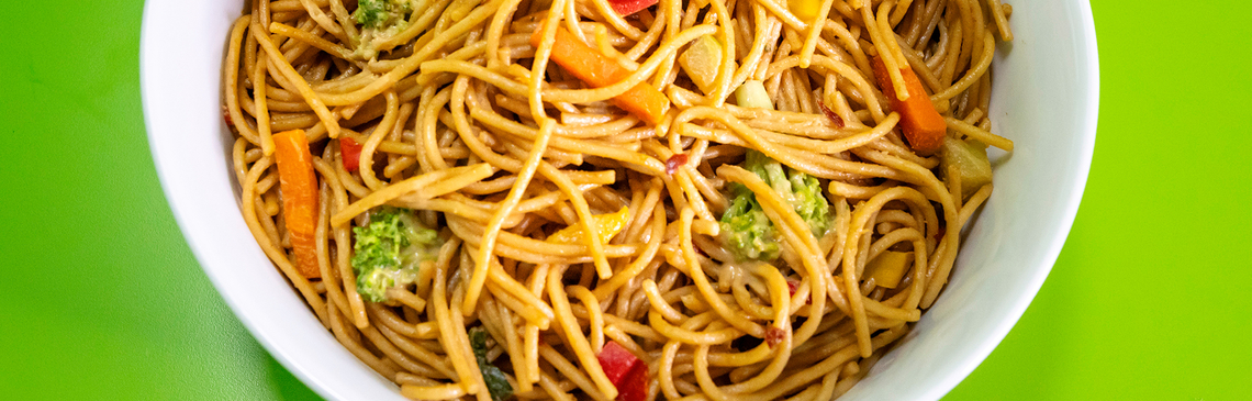 A large white bowl filled with Noodles and Peanut Sauce
