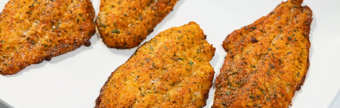 A white platter filled with Parmesan Crusted Catfish