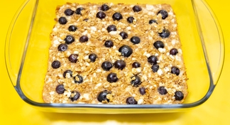 A pan of Blueberry Breakfast Bake on a yellow background