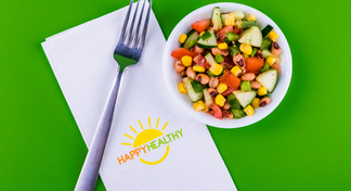 Fork and napkin beside bowl with black-eyed pea salad.