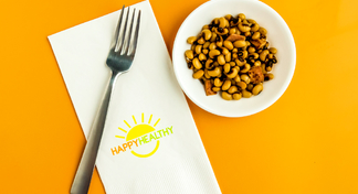 bowl of black-eyed peas beside fork and napkin.