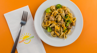 Chicken Broccoli Skillet recipe plated with a fork on a HappyHealthy napkin.