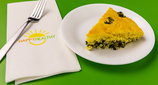 An eighth wedge of cornbread and greens