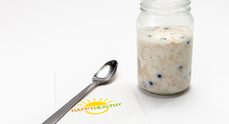 Jar of overnight oats next to HappyHealthy napkin and spoon