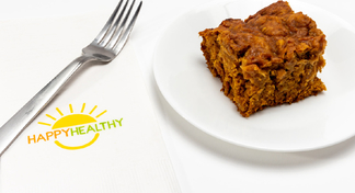 A pineapple pumpkin square on a white plate next two a fork and Happy Healthy napkin