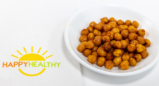 A white plate with roasted chick peas next to a Happy Healthy napkin