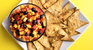 plate with bowl of fruit salsa and tortilla chips