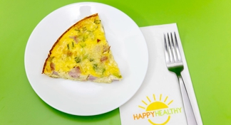 A plate with a wedge of Crustless Ham and Cheese Quiche